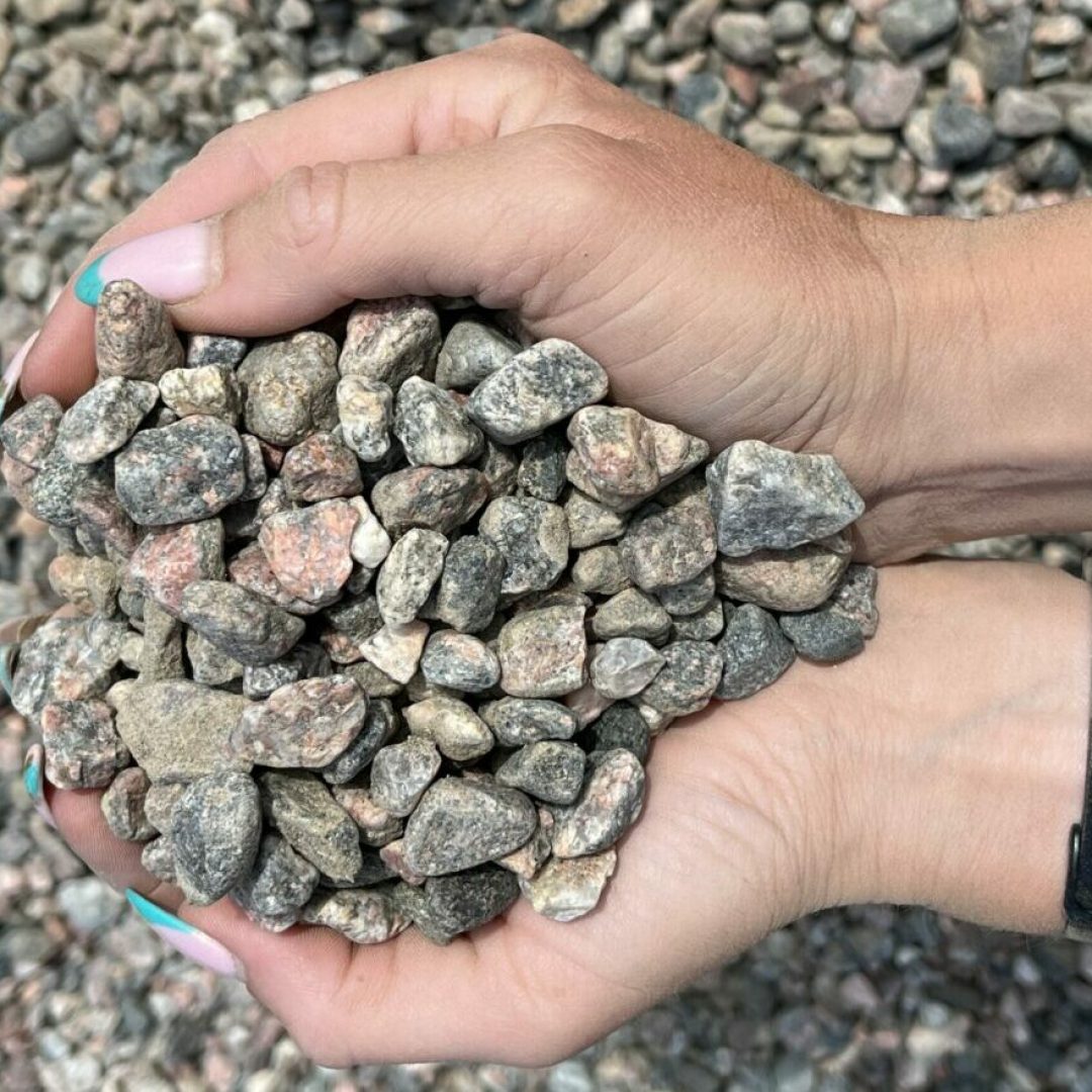 Hand som håller i gårdsgrus